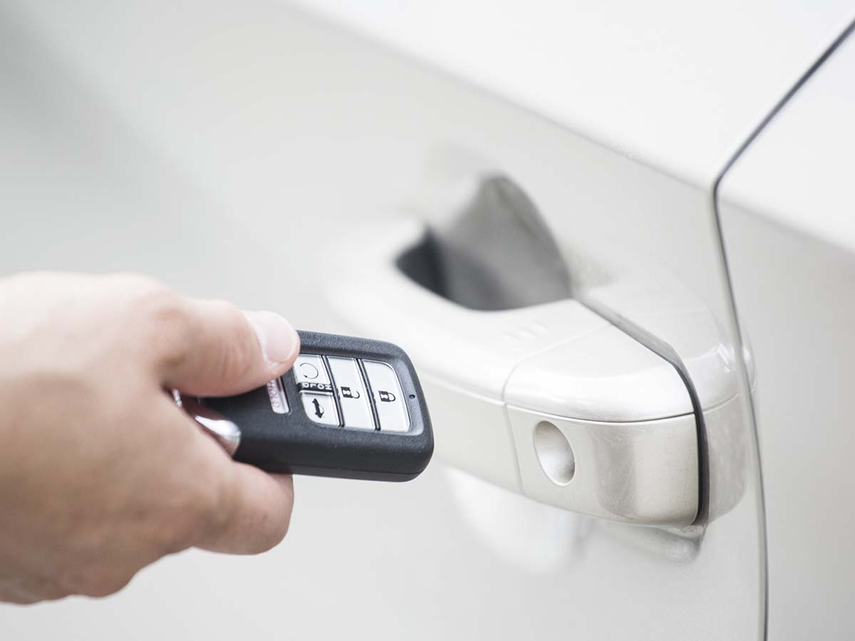 Key fob unlocking the door of a car