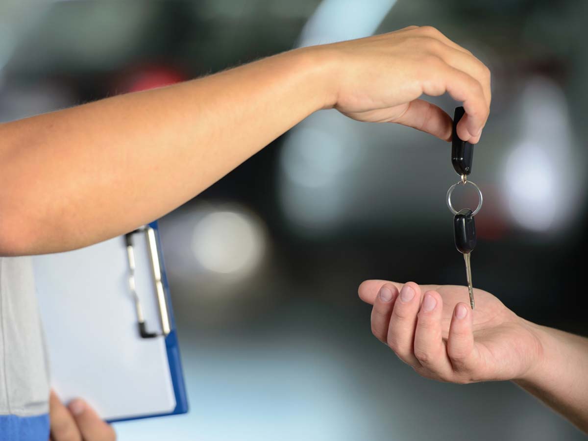 tech handing over a car key copy