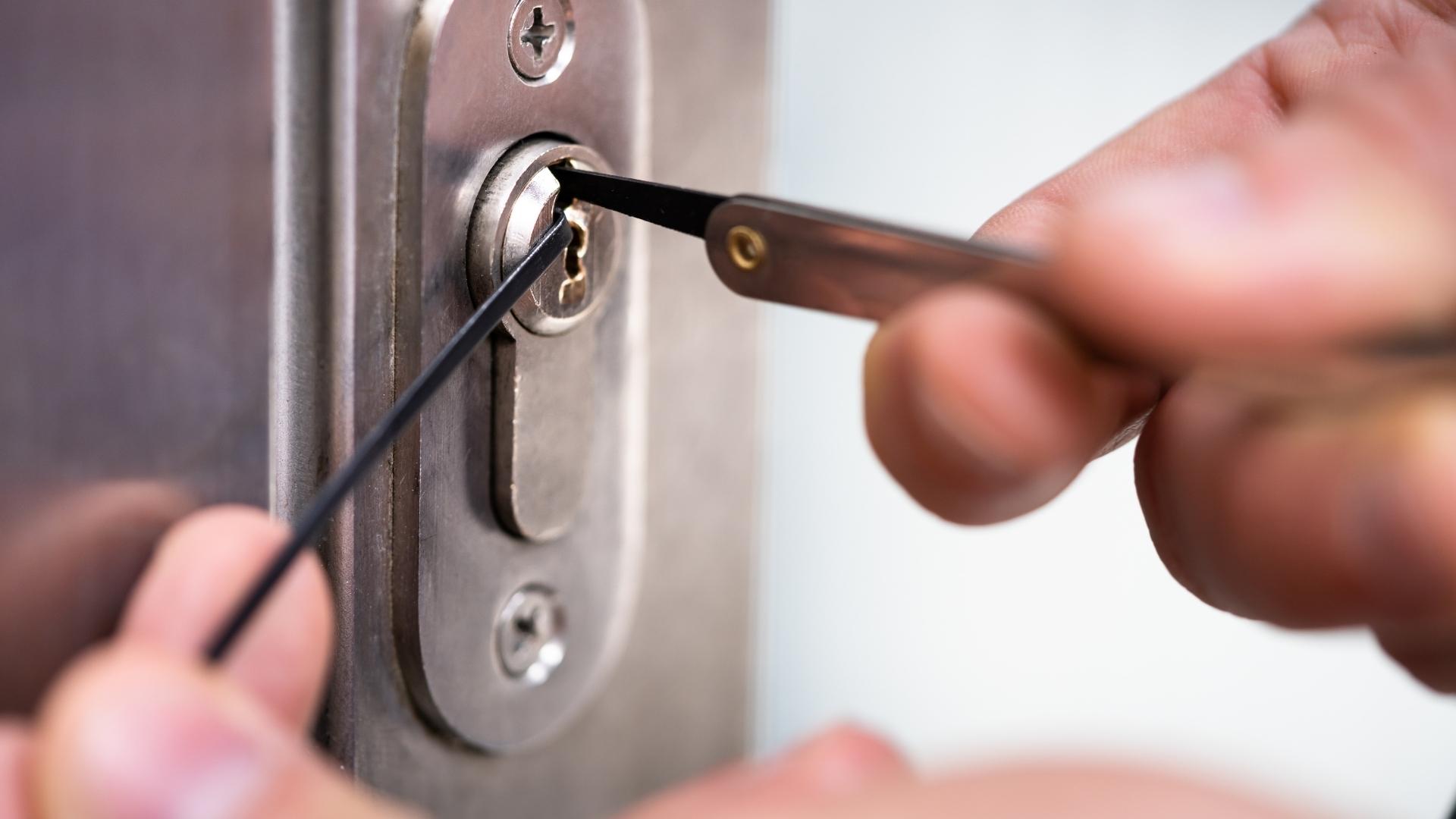 Locksmith working on unlocking the door to a home