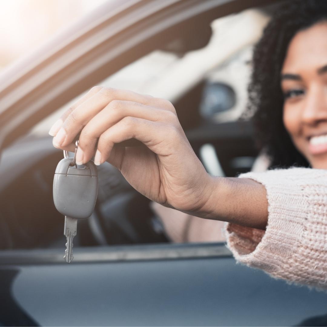 Woman smiling holding car keys