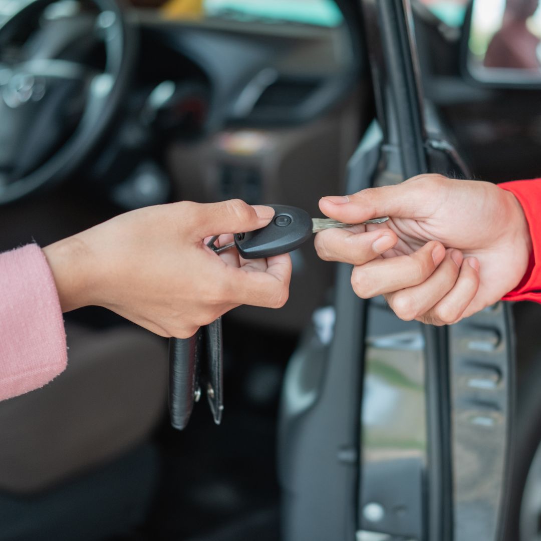 Person handing car key to another person