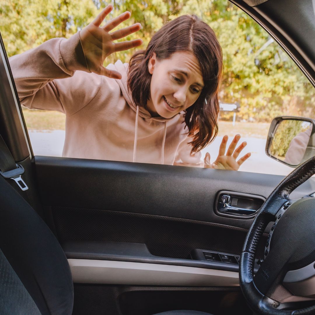 woman looking into car